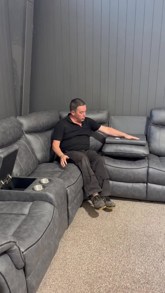 Grey leather corner recliner suite with cup-holder console at Mattress Madness Portlaoise